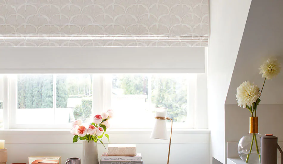 A Roller Shade is layered under a Roman Shade which emphasizes the differences between roller shades vs roman shades