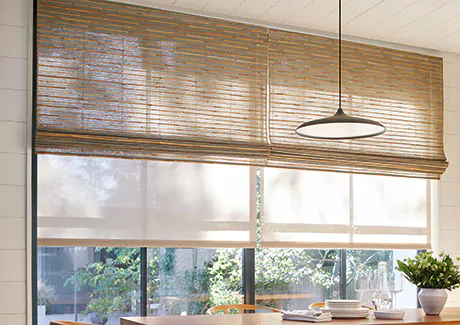 Woven Wood Shades are used as sunroom window treatments along with Roller Shades for optimal light and privacy control