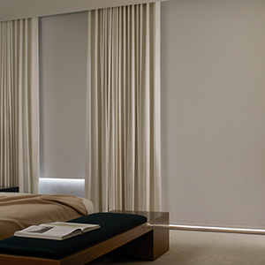 Types of blinds include Roller blinds made of Cora Blackout in White with helps darken a modern bedroom for better sleep