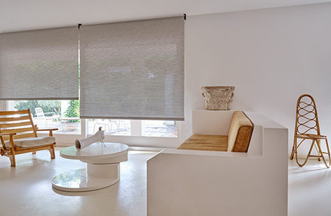 Roller Shades made of Mesa Verde in Mist offer a cool grey tone to a mid-century modern room with warm wood tones