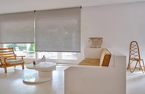 Roller Shades made of Mesa Verde in Mist offer a cool grey tone to a mid-century modern room with warm wood tones