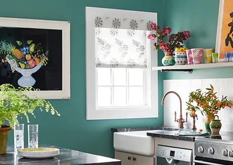 A Roller Shade made of Sheila Bridges Florentine material in Grigio is used as an alternative to blinds on a kitchen window