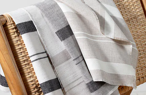Sunroom window treatments benefit from hardy fabrics like Shoreham Stripe made of a linen blend to withstand sun exposure