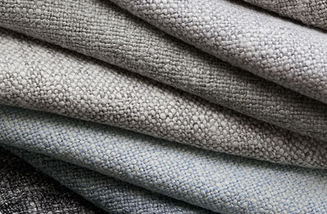 Heathered Linen fabric in different colors is neatly folded and offers a warm, textured look for linen Roman Shades