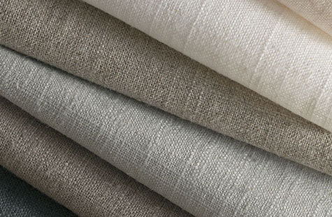 Linen Blend fabric in neutral colors is stacked neatly and features a simple textured look for linen Roman Shades