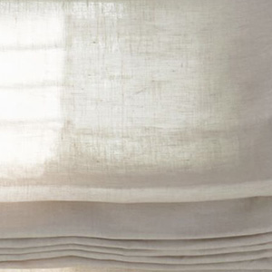 Linen Sheers is partially folded and offers a delicate look and lots of light filtration for linen Roman Shades