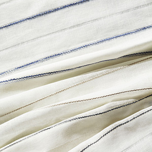 Swatches of Martyn Lawrence Bullard's Sahara Stripe are layered together and showcase the simple, yet distinct stripe
