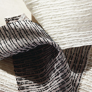 Swatches of Martyn Lawrence Bullard's Tangier Weave are decoratively laid together and show the rich texture of the fabric