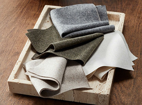 Roman Shade swatches from the Nate Berkus Lowell Tweed Collection are decoratively arranged to show their soft texture