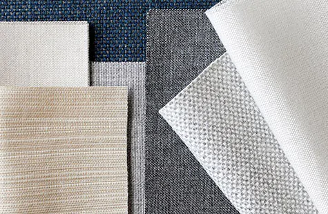 Roman Shade swatches made of fabrics from the Sunbrella Ventana Collection are laid flat and feature neutral colors