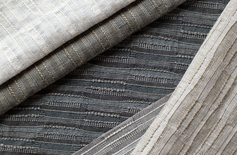 Upton fabric in different colors is layered over each other and offers visual and tactile texture for linen Roman Shades