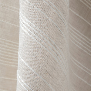 A swatch of Victoria Hagan's Tidal Line is gently folded to showcase the subtle striped design inspired by tidal waters