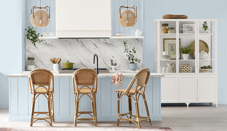 A kitchen is painted with Sherwin-Williams' color of the year 2024, Upward, a soft, sky blue for a bright welcoming look