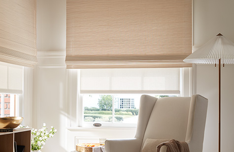 A playroom has layered window treatments of Woven Wood Shades, Somerset in Cloud and Solar Shades, 1% Solistico in Oatmeal