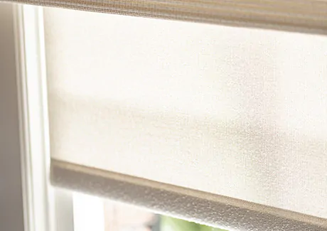 A close up of Solar Shades as nursery window treatments shows the neutral color and UV-blocking material for a cooler room