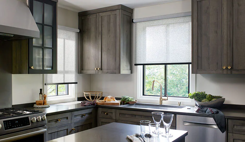A kitchen with light filtering Solar Shades in 3% Solistico, Ash, shows the difference between Solar Shades vs Roller Shades