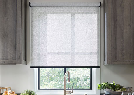 Types of blinds and shades include Solar Shades made of Sunbrella 3% Solistico in Ash over a sink in a grey modern kitchen