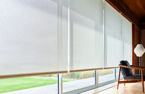 Window coverings in a modern open space include Solar Shades made of Sunbrella 10% Solistico in Oatmeal