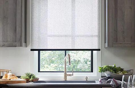 To compare light filtering vs blackout a kitchen has a Solar Shade of 3 percent Solistico in Ash which brightens the room