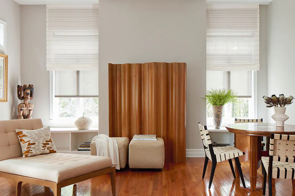 A scandi-chic living room doesn't have to decide between roller shades vs romans shades because it layers both