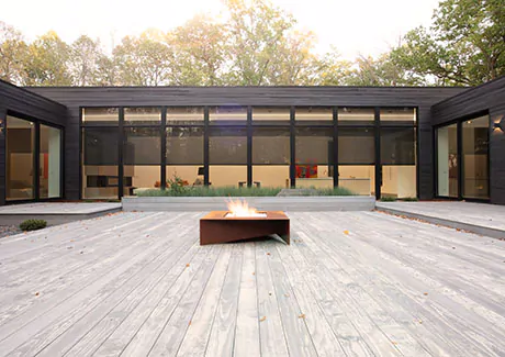 A modern home has Solar Shades made of 10% material in Black that you can't really see through during the day from the deck