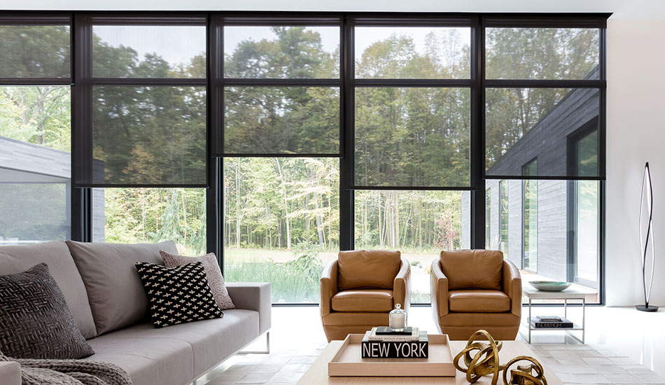 Solar shades for windows pulled to varying heights on a series of paned glass windows in a living room