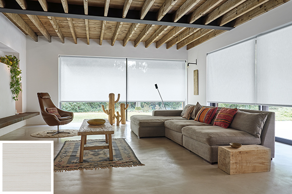 A southwestern-styled living room with corresponding decor and multiple solar shades for windows acting as treatments
