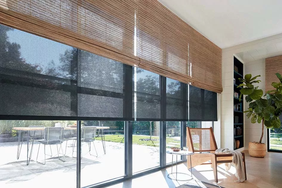 Mid century modern window treatments include light waterfall woven wood shades layered with black 5% solar shades