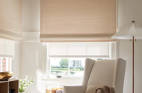 A Woven Wood Shade made of Somerset in Cloud is layered with a Solar Shade made of 1% Solistico in Oatmeal in a playroom