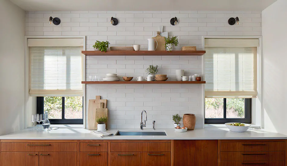 Contemporary window treatments in a modern farmhouse kitchen include standard woven wood shades in an inviting muslin color
