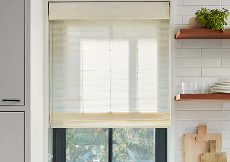 A farmhouse kitchen has Woven Wood Shades made of Coastline in Muslin with no lining for some privacy and lots of light