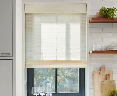 Window Shades in a modern farmhouse kitchen include Standard Woven Wood Shades made of Coastline in Muslin to match the decor