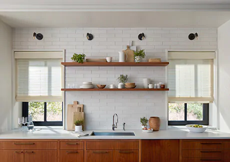 Farmhouse window treatments of Woven Wood Shades made of Coastline in Muslin adorn the windows a modern farmhouse kitchen