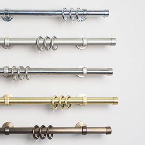 The collection of Steel Hardware for curtain rods shows several finishes some shiny and some tarnished for a worn look