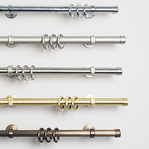 A display of Steel Hardware shows four shiny rods with different colors ranging from light silver to deep bronze