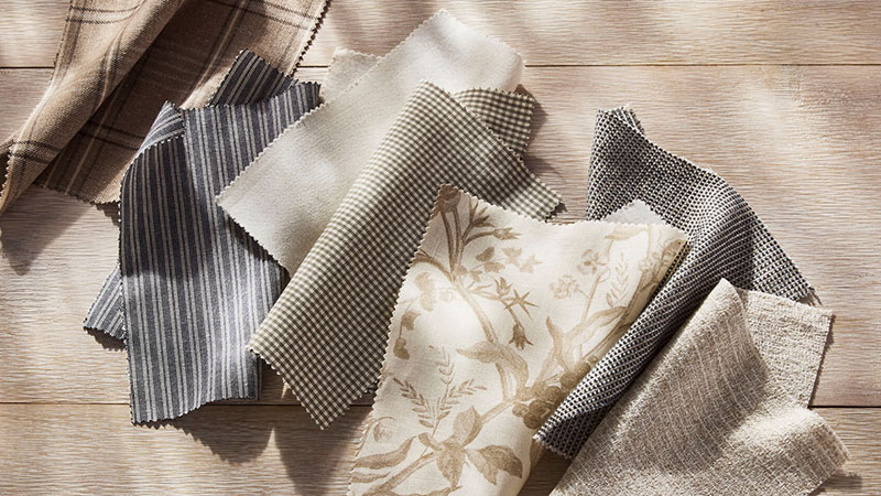 Fabric swatches from the Studio McGee collection for The Shade Store are laid in dappled sunlight