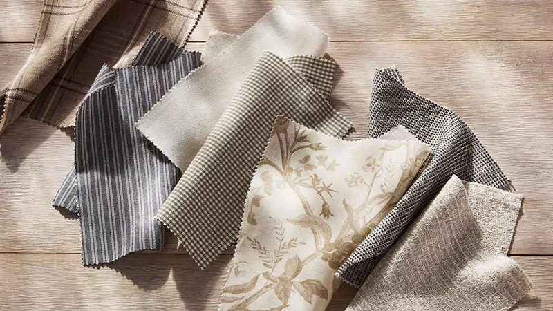 Fabric swatches from the Studio McGee collection for The Shade Store are laid in dappled sunlight