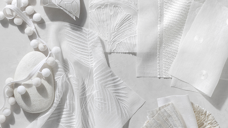 A close-up image of white swatches featuing different textures and materials shows the declicate details of these designs