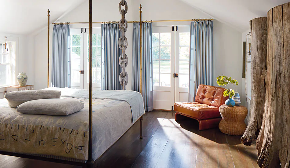 Tailored Pleat Drapery made of Andes in Lake hang over two sets of French doors in a rustic coastal themed bedroom