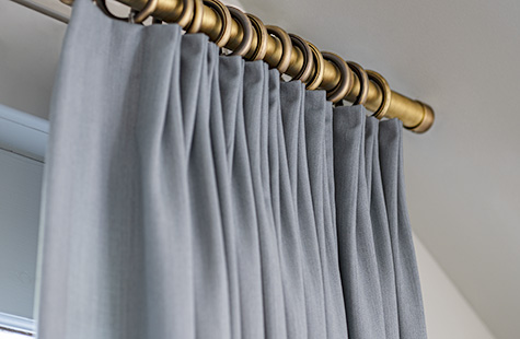 A close up of Tailored Pleat Drapery made of Andes in Lake shows the streamlined, clean aesthetic of this style