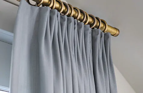 A close up of Tailored Pleat Drapery made of Andes in Lake shows the streamlined, clean aesthetic of this style