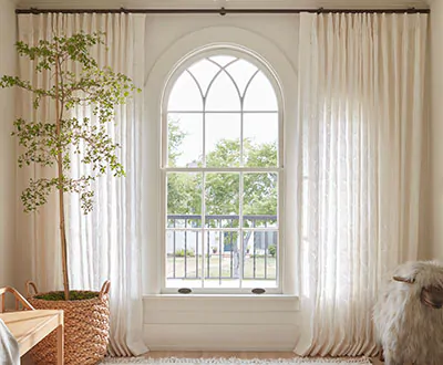 Curtains for arched windows made of Feather Palm Embroidery, Vintage Lace, add elegance to a standard arch window