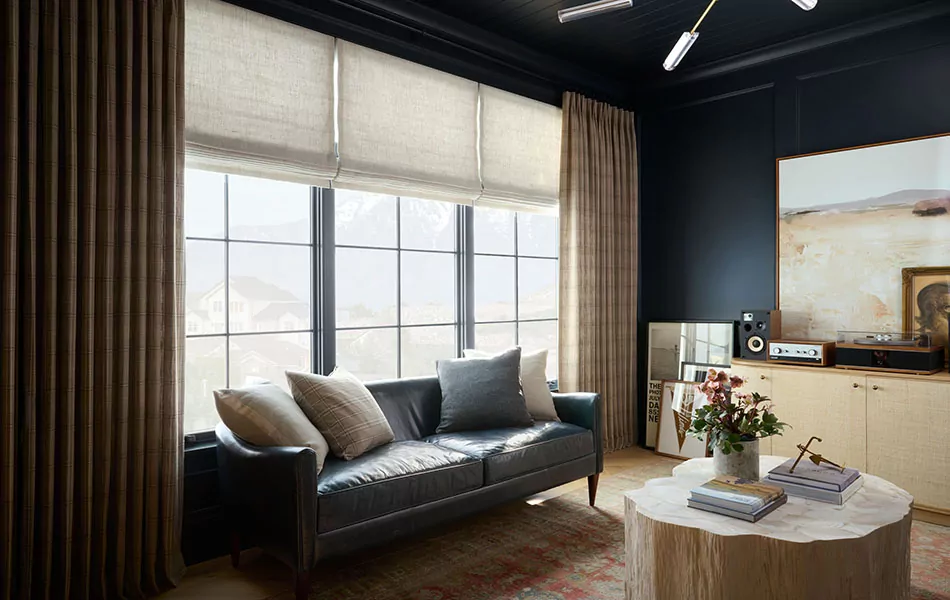 Drapery in Field Plaid in Canyon and Roman Shades in Textured Multiweave in Almond add depth to a dark office
