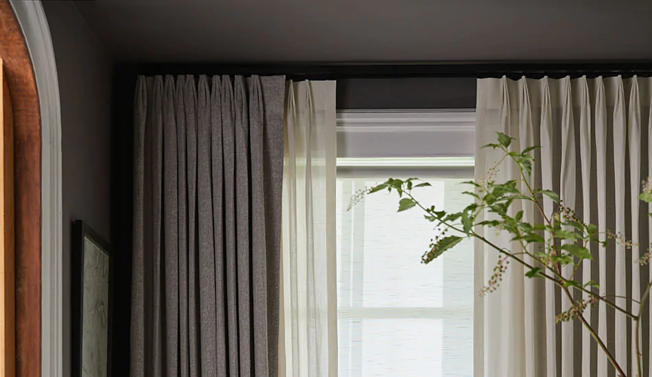 Dark gray curtains hang above a window with crown molding show how to hang curtains on windows with crown molding