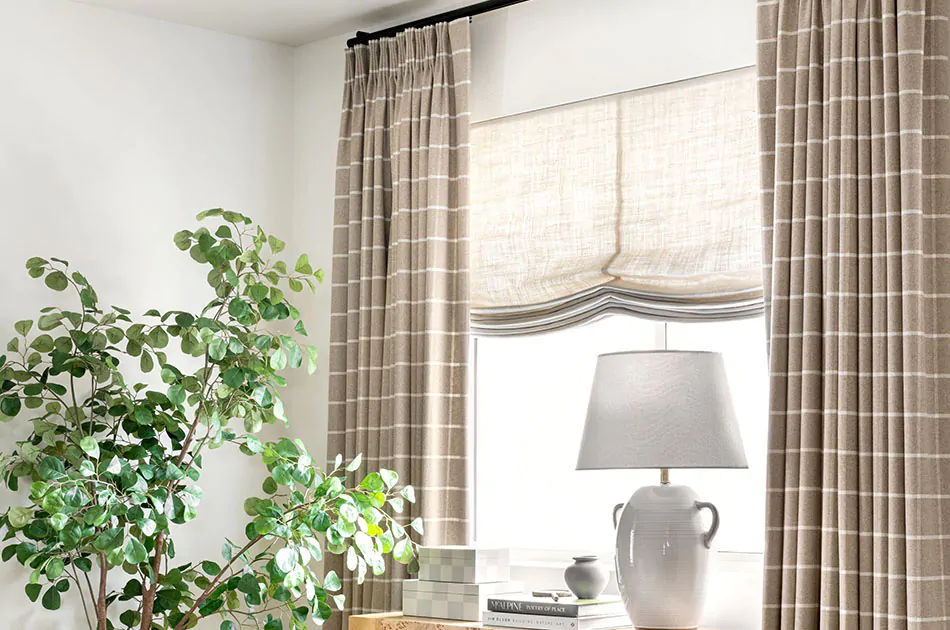 Plaid curtains in a Tailored Pleat Drapery style with Relaxed Roman Shades work in tandem in a game room
