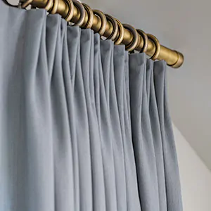 A close up of coastal window treatments, Tailored Pleat Drapery made of Andes in Lake shows the three-finger pleats