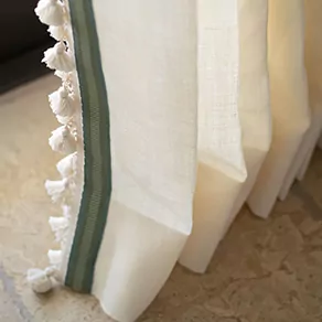 A detail image shows Luxe Linen drapes in Oyster with elegant trim for living room curtain ideas