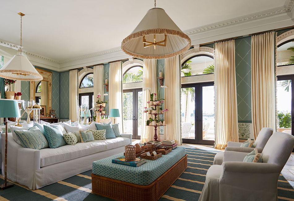 Doors with arched window open to the outdoors with tailored pleat drapes showing living room curtain ideas