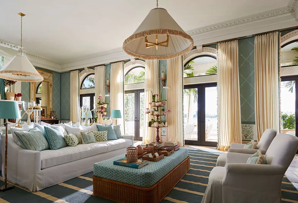 Doors with arched window open to the outdoors with tailored pleat drapes showing living room curtain ideas