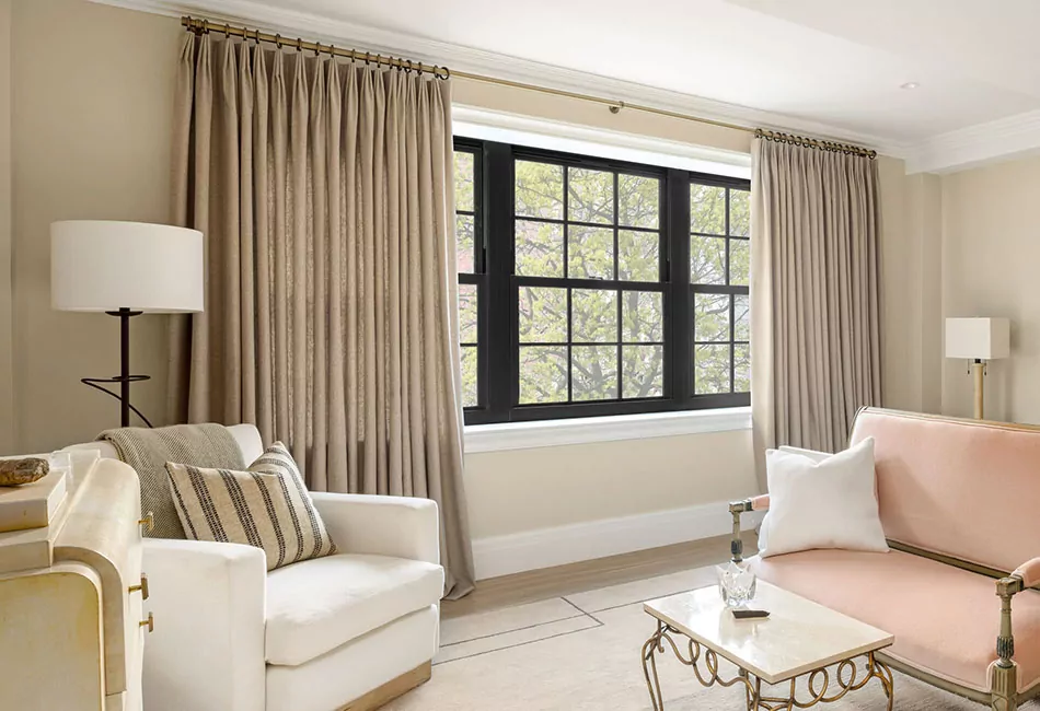 Living room curtain ideas include Tailored Pleat Drapes made of Lowell Tweed in Oak for a cozy room